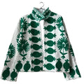 ront view of an open-style handmade white textured cotton TNT short jacket featuring bold, large-scale emerald green Suzani embroidery with floral and botanical motifs, isolated against a solid white background.