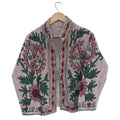 Light beige textured TNT jacket featuring hand-embroidered dusty pink paisley motifs, large flowers, and winding dark green vines.