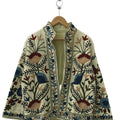 A Neutral Canvas for Earthy Bohemian Art
Bring a beautifully textured and highly artistic layer to your everyday style with our Handmade TNT Suzani Embroidered Jacket. Crafted on a versatile, cream-colored textured TNT cotton canvas, this open-front jacket provides a clean, neutral backdrop that makes its earthy embroidery truly stand out. The symmetrical front panels showcase stunning high-density Suzani-style threadwork, featuring large floral fans and blooms in dusty blue, muted burgundy, and warm tan, a