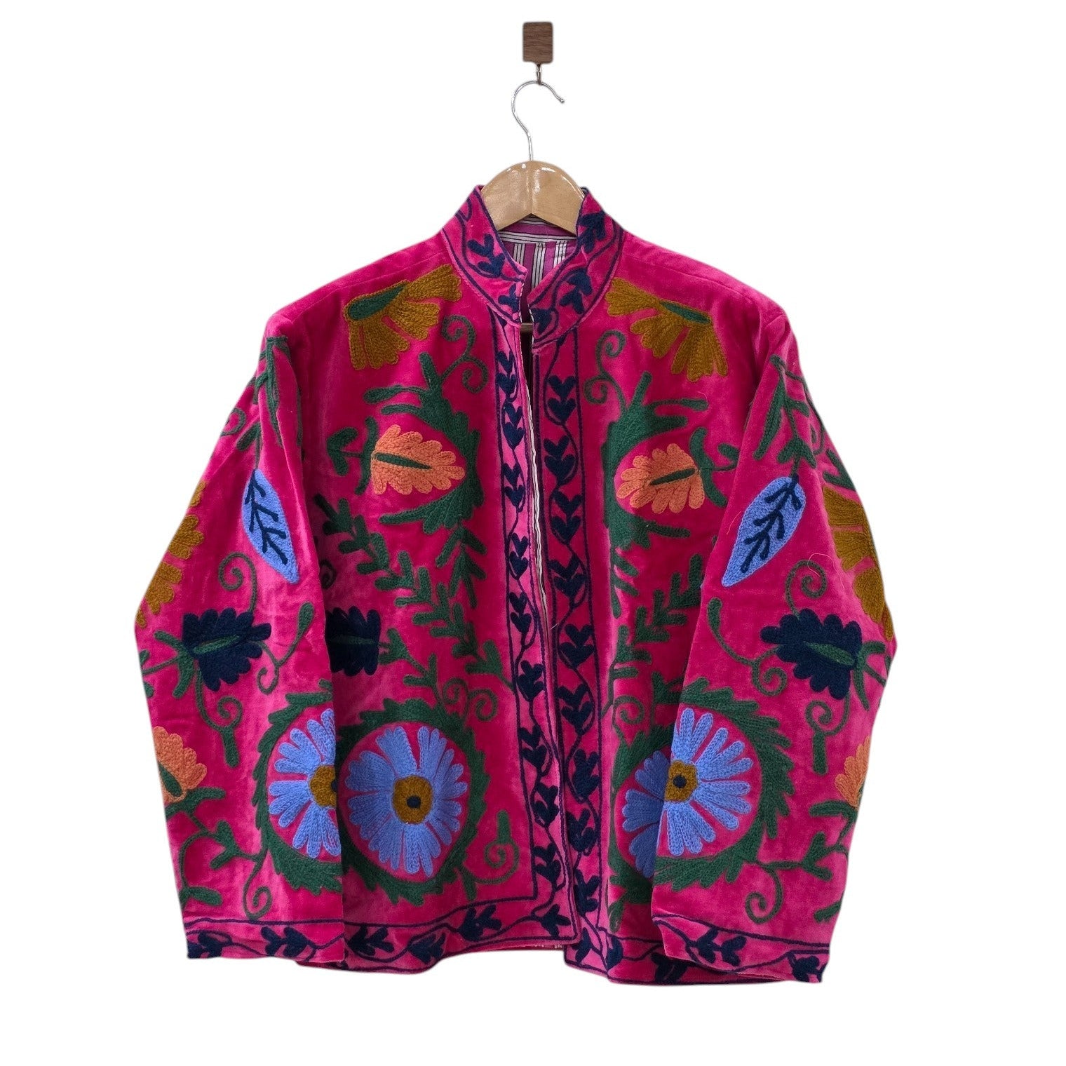 Magenta pink velvet Suzani jacket featuring intricate hand-embroidered periwinkle blue flowers and green botanical vines.