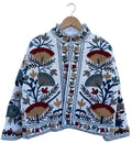 White textured TNT jacket featuring symmetrical hand-embroidered geometric flowers in deep red, mustard gold, and dark navy.