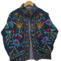 Handmade Indian black Kantha embroidered Suzani tnt jacket featuring a multicolored floral pattern, long sleeves, and a contrasting striped lining.