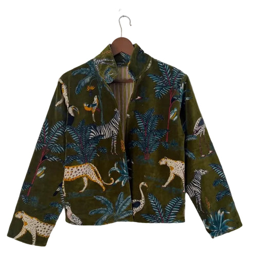 Back view of a dark green velvet TNT jacket featuring a colorful tropical safari print with cheetahs, zebras, exotic birds, and palm leaves.