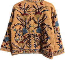 Front view of a mustard yellow open-front TNT jacket featuring intricate blue, red, and beige floral embroidery, dark vines, and a thin striped interior lining.