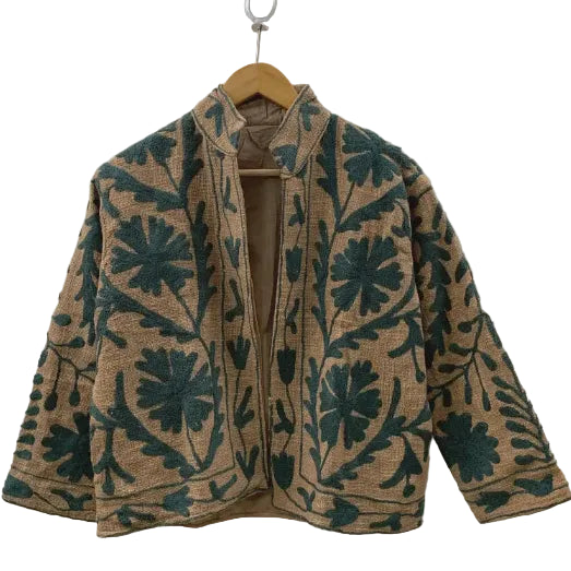 Front view of an open-style handmade khaki textured cotton TNT short jacket featuring dark green monochrome Suzani floral and vine embroidery, showcasing a solid tan interior lining.